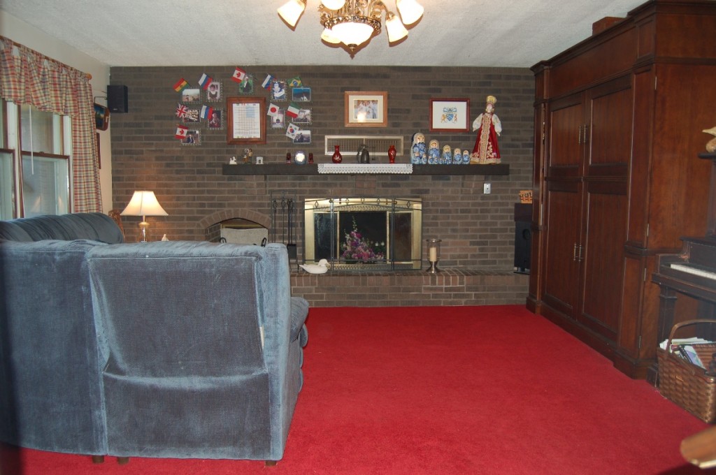 The rough-sawn hardwood mantle of our oversized brown-brick fireplace. (Of course this was after the adoptions)