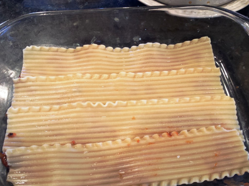 Spread a small amount of Monster Spaghetti Sauce over bottom of 9"x 13" baking pan.  Lay four lasagna noodles for base layer and spread 2 cups of sauce over noodles.  